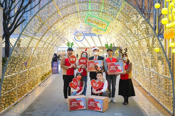 롯데물산은 21일과 22일 송파구 1인가구 200세대에게 해피박스를 전달한다. 류제돈 롯데물산 대표이사(뒷줄 가운데)와 롯데물산 임직원들이 롯데월드타워 아레나광장 루미나리에 터널에서 기념촬영을 하고 있다. /사진=롯데물산