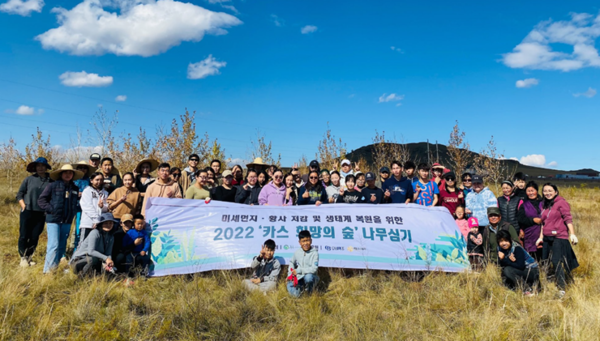 몽골 학생 봉사단이 몽골 북동부 에르덴솜 지역에서 나무심기 봉사활동 마치고 단체 사진을 찍고 있다. / 사진=오비맥주