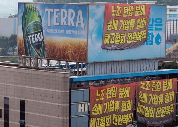2022년 8월 22일 오전 전국민주노동조합총연맹(민주노총) 공공운수노조 화물연대가 점거 농성 중인 서울 강남구 하이트진로 본사에 현수막이 걸려 있다./연합