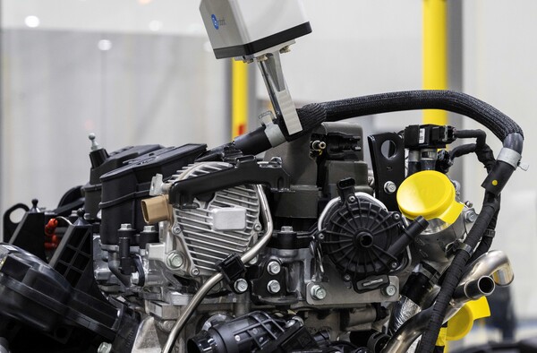 AI 비전 알고리즘 판단을 통해 로봇이 호스 부품의 형체를 인식하고 들어올려 엔진에 조립하고 있다./사진=현대자동차