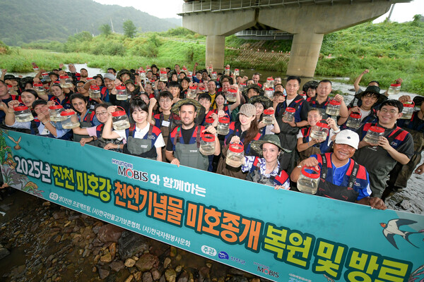 2025년 9월 17일 충북 진천 미호강 일대에서 현대모비스 국내·외 임직원들이 멸종위기종인 미호종개 치어 방류 행사에 참여하고 있다./사진=현대모비스